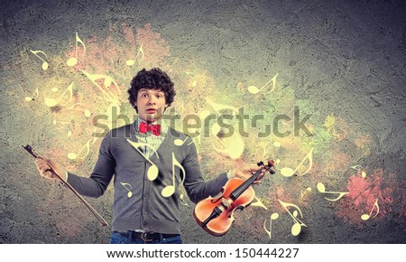 Image of young handsome man playing violin