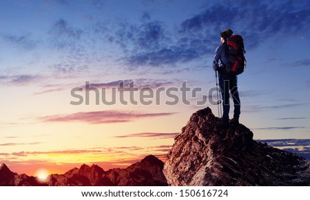 Image of young man mountaineer standing atop of rock ストックフォト © 