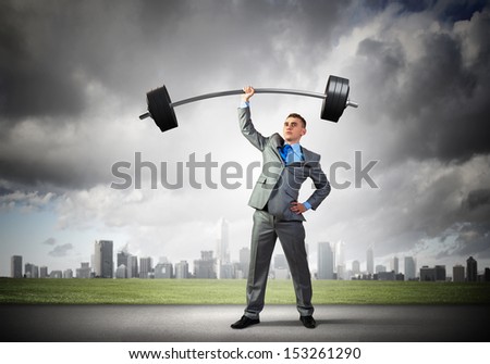Image of strong businessman lifting barbell above head with one hand