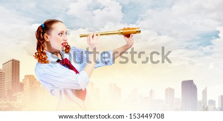 Image of young pretty woman looking in telescope