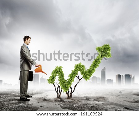 Image of businessman watering plant shaped like arrow