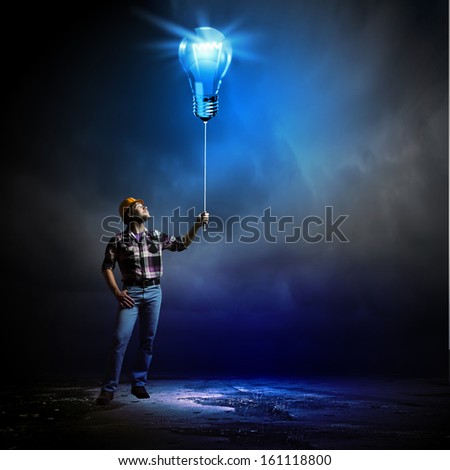 Image of man builder holding electrical bulb