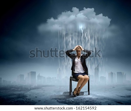 Image of young troubled businesswoman standing under rain