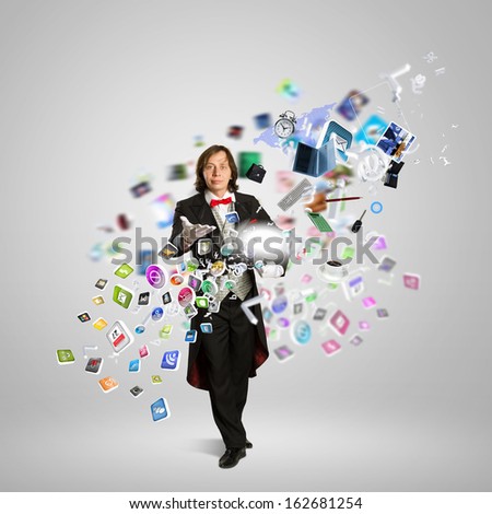 Image of magician with hat and computer devices flying in air