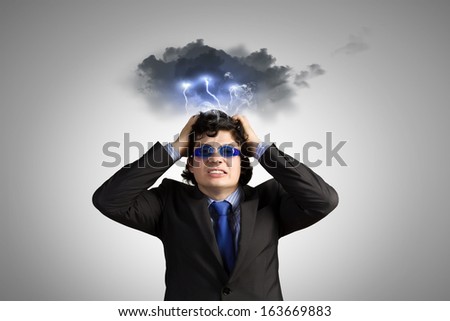 Image of depressed businessman tearing his hair
