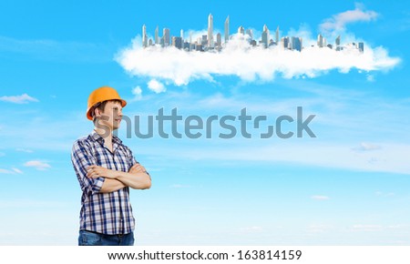 Image of thoughtful man builder with arms crossed on chest