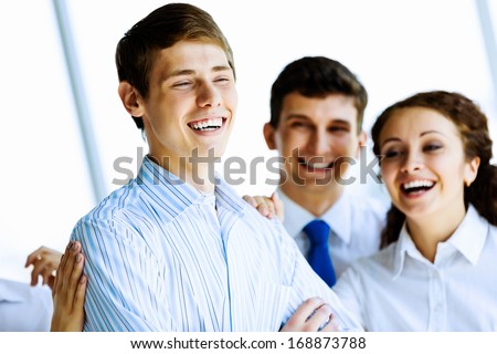 Image of business people at meeting laughing joyfully