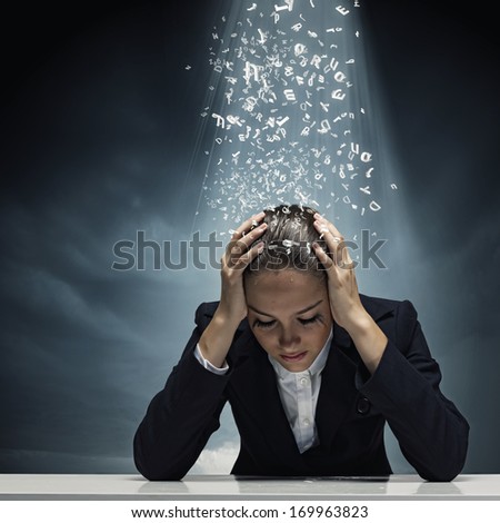 Young crying businesswoman with hands on head