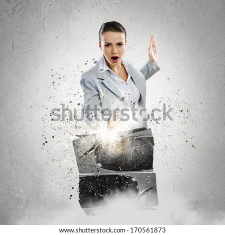 Image of young businesswoman damaging computer processor