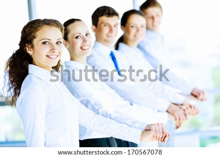 Image of young business people standing in line. Interaction concept