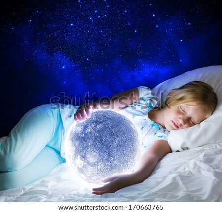 Girl lying in bed with moon in hands