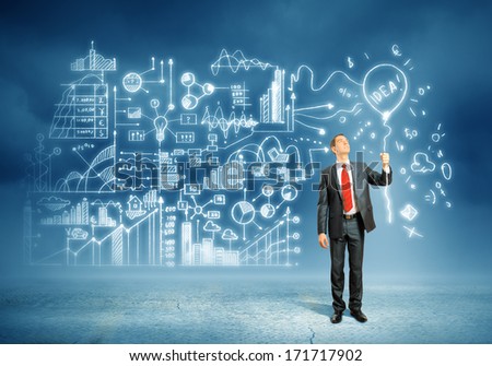 Image of young businessman standing against business sketch