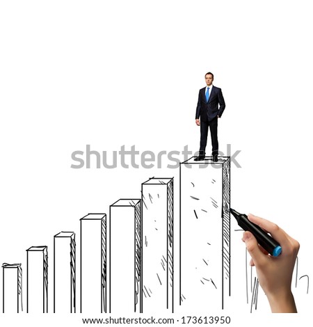 Successful businessman standing on drawn graph bars