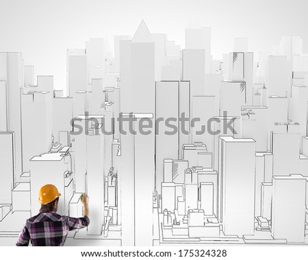 Back view of man engineer drawing buildings