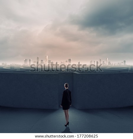 Businesswoman standing near the enter of labyrinth