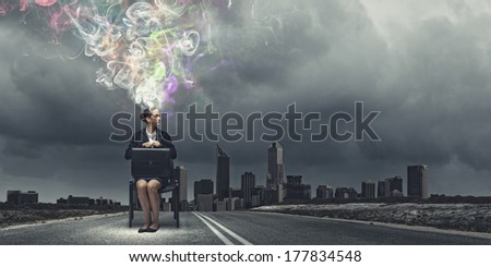 Thoughtful businesswoman with colorful fumes above head