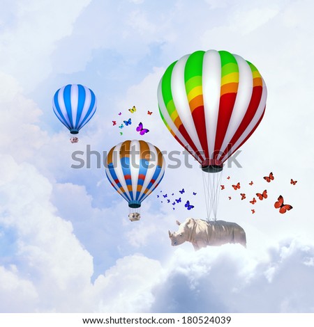 Rhino flying high in sky on colorful aerostat