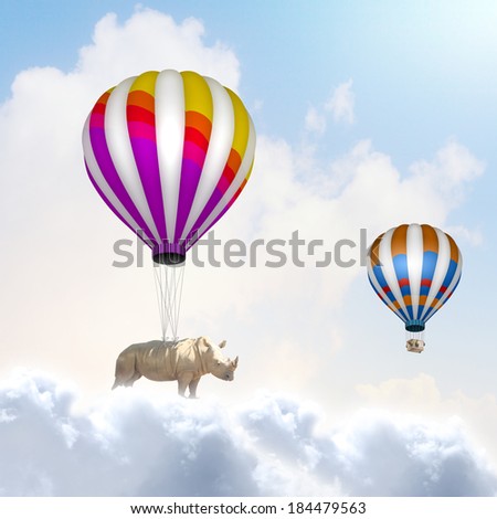 Rhino flying high in sky on colorful aerostat