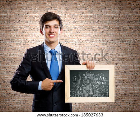 Close up of businessman holding frame with business sketch