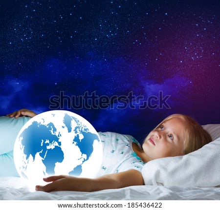 Girl in bed with Earth planet in hands