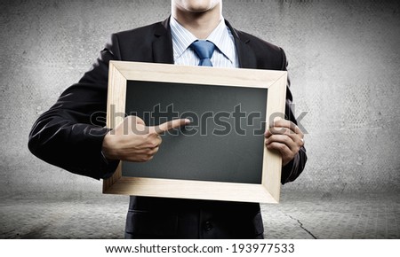 Handsome businessman holding blank frame. Place for text