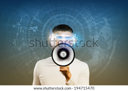 Young man in white screaming in megaphone against media background