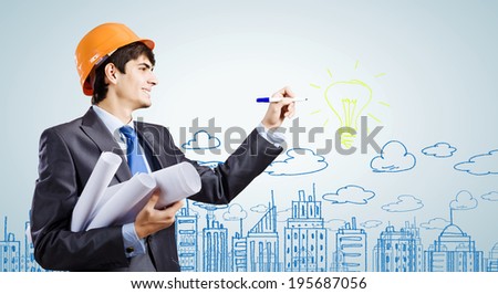 Young man engineer drawing sketches of construction project