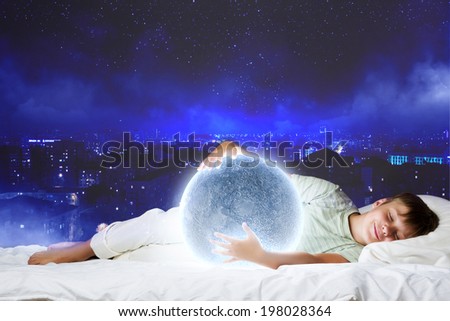 Cute boy sleeping in bed with moon