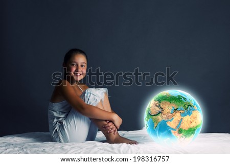 Cute girl sitting in bed and looking at Earth planet. Elements of this image are furnished by NASA