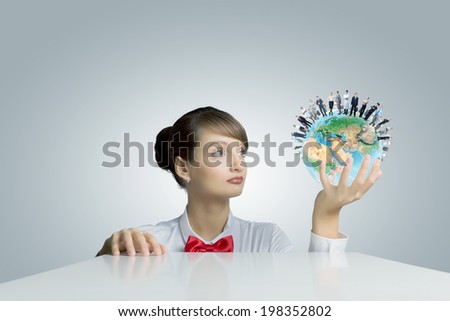 Young smiling woman holding Earth planet in hand. Elements of this image are furnished by NASA
