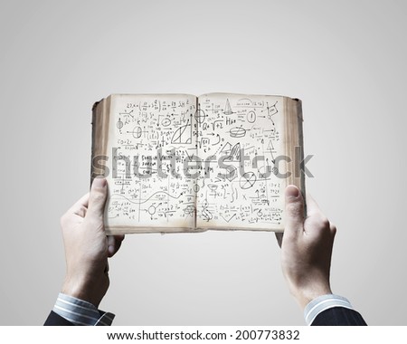 Close up of businessman hands holding opened book with sketches
