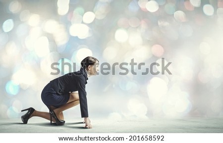 Side view of businesswoman in suit ready to run