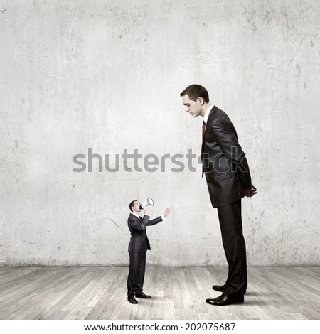 Big Bossy Businessman Looking Down At Small Businessman Stock Photo ...
