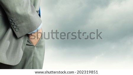 Close up of confident businessman with hands in pockets
