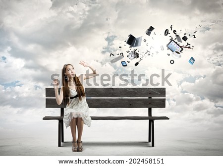 Young pretty scared asian woman sitting on bench