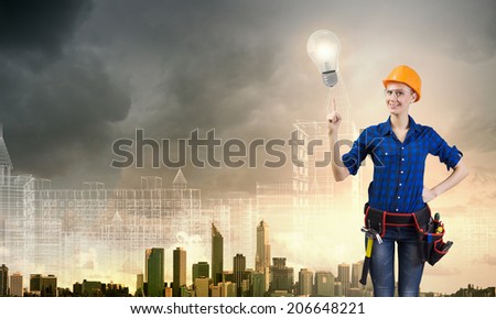 Young pretty woman engineer with tool belt on waist