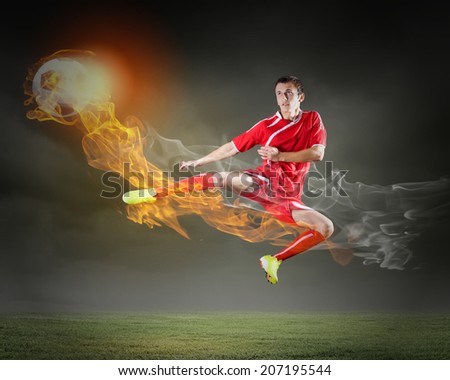 Young football player on stadium in jump taking ball