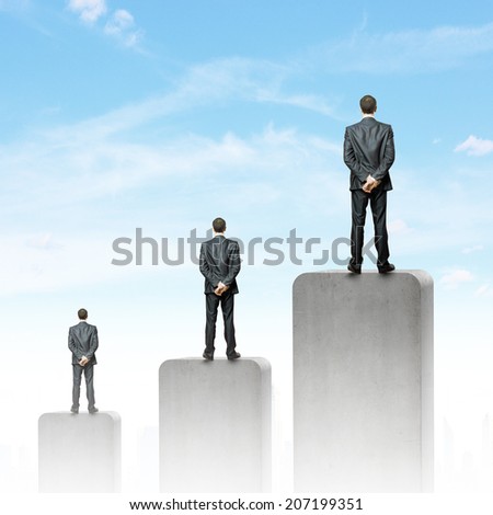Businessman standing on top of graph bar