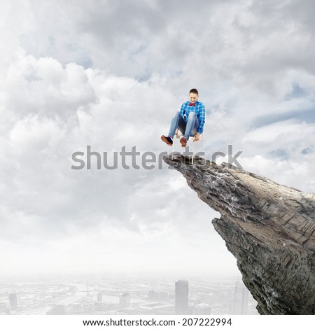 Young woman in casual sitting in chair on top of rock