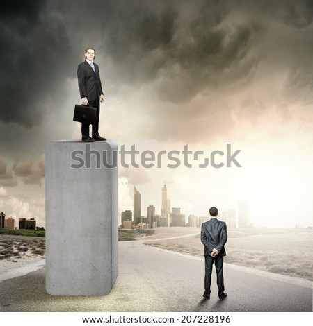 Businessman standing on top of graph bar