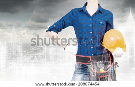 Bottom view of woman engineer with tool belt on waist