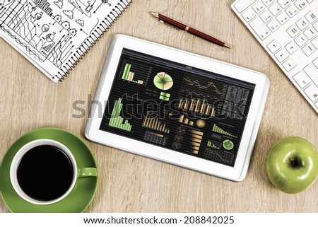 Close up image of tablet pc apple cup of coffee on table
