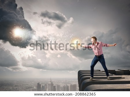 Young man in casual throwing star dust