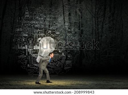 Tired businessman carrying light bulb on his back