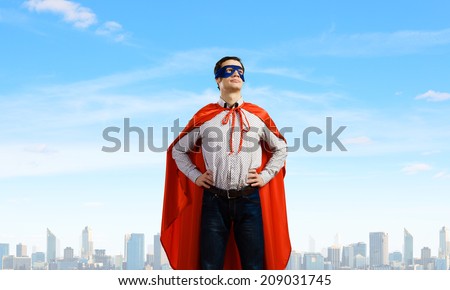 Young man wearing a mask and cape