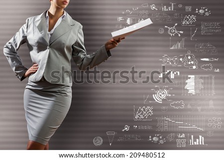 Businesswoman holding papers in hand and business sketches at background