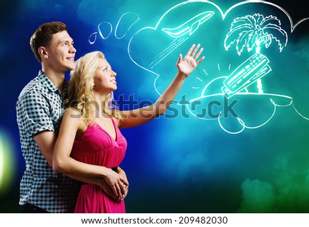 Young happy couple dreaming about future vacation