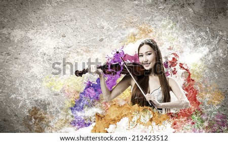Young pretty asian woman playing violin. Young talent