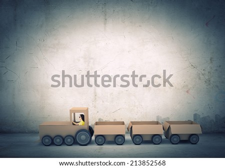 Young woman riding carton train. Women in business