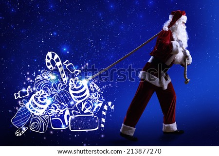 Santa Clause and Christmas gifts against blue background